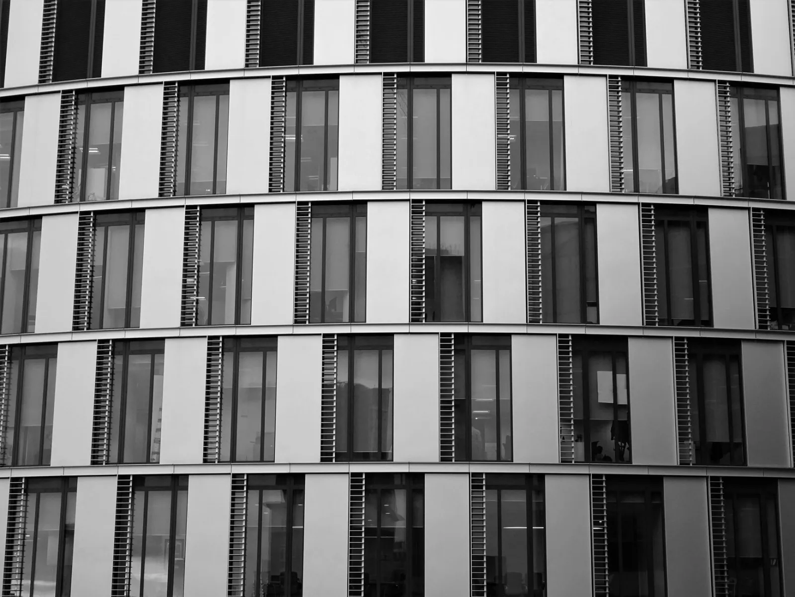 Close-up view of a contemporary office building exterior with glass and steel elements.